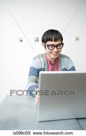 Stock Image - Young man with notebook. Fotosearch