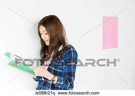 Young woman looking at design book View Large Photo Image Stock Photography - Young woman looking at design book. Fotosearch