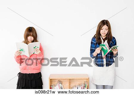Young women reading books View Large Photo Image Stock Photo - Young women reading books. Fotosearch