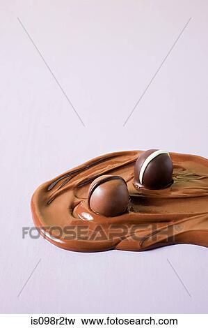 Chocolates in melted chocolate View Large Photo Image Stock Photo - Chocolates in melted chocolate. Fotosearch