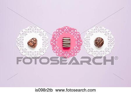 Chocolates on doilies View Large Photo Image Stock Image - Chocolates on doilies. Fotosearch