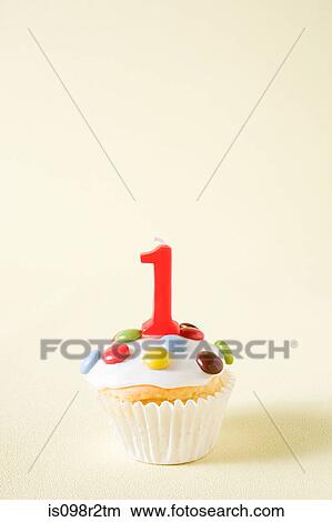 Picture - Cupcake with number one candle. Fotosearch