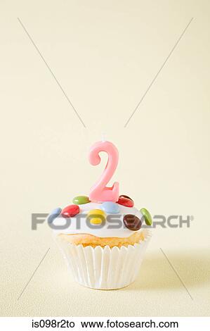 Picture - Cupcake with number two candle. Fotosearch