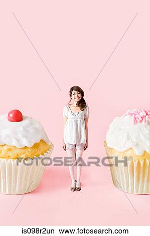 Small woman and big cakes View Large Photo Image Picture - Small woman and big cakes. Fotosearch