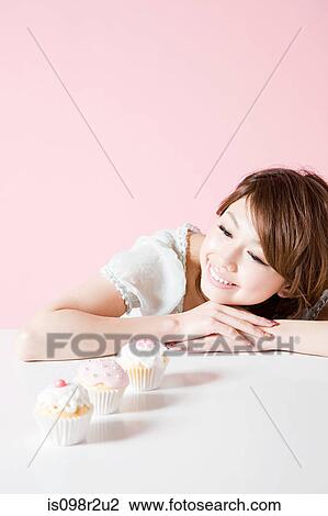 Woman looking at cakes View Large Photo Image Stock Image - Woman looking at cakes. Fotosearch