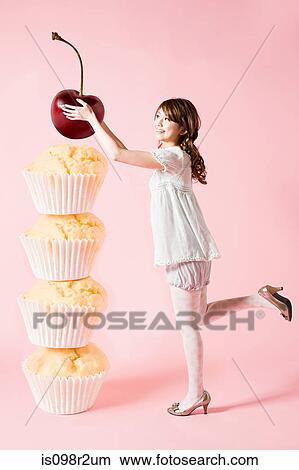 Woman with cherry and cupcakes View Large Photo Image Picture - Woman with cherry and cupcakes. Fotosearch