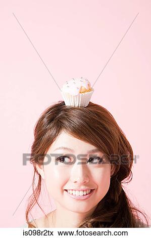 Woman with cupcake on her head View Large Photo Image Stock Photo - Woman with cupcake on her head. Fotosearch