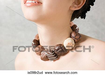 Woman with necklace of chocolates View Large Photo Image Stock Image - Woman with necklace of chocolates. Fotosearch
