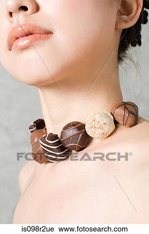 Woman with necklace of chocolates View Large Photo Image Stock Image - Woman with necklace of chocolates. Fotosearch