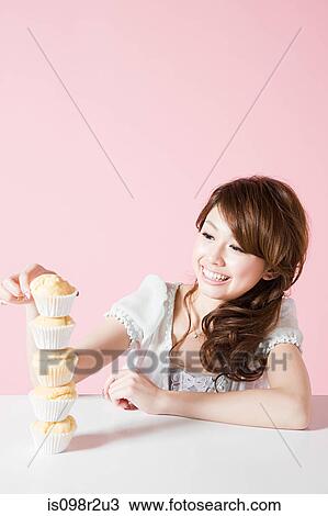 Woman with stack of cakes View Large Photo Image Stock Image - Woman with stack of cakes. Fotosearch