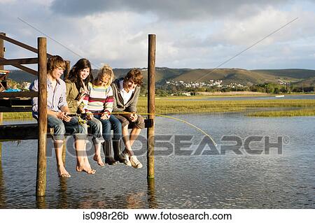 Stock Image - Friends on a jetty. Fotosearch