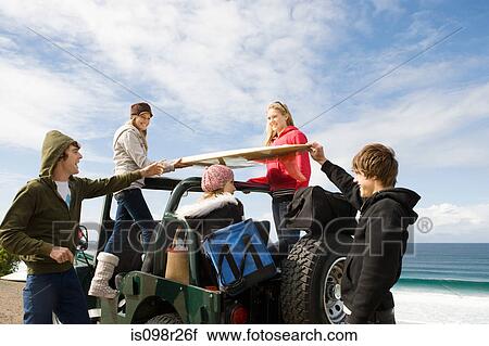 Surfer friends at the coast View Large Photo Image Stock Image - Surfer friends at the coast. Fotosearch
