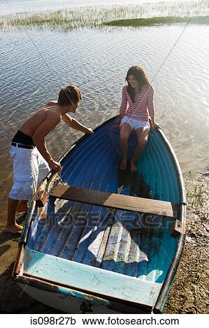 Teenage couple with rowboat View Large Photo Image Stock Image - Teenage couple with rowboat. Fotosearch