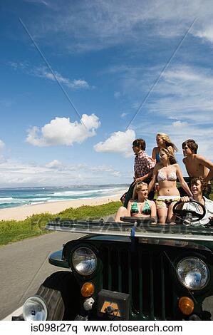 Stock Photography - Teenager in vehicle at the coast. Fotosearch