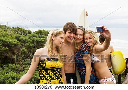 Teenager surfers with camera View Large Photo Image Stock Image - Teenager surfers with camera. Fotosearch