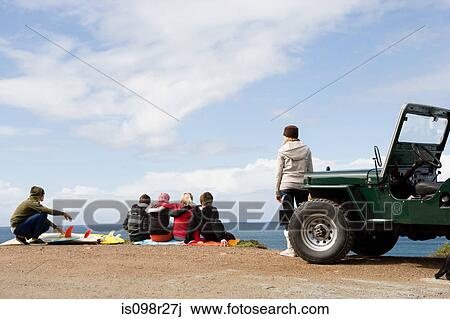 Teenagers at the coast with off road vehicle View Large Photo Image Stock Image - Teenagers at the coast with off road vehicle. Fotosearch