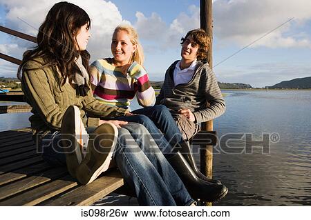 Teenagers on jetty View Large Photo Image Stock Photo - Teenagers on jetty. Fotosearch