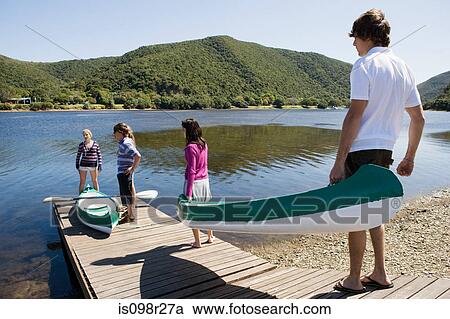 Teenagers with canoes View Large Photo Image Stock Image - Teenagers with canoes. Fotosearch