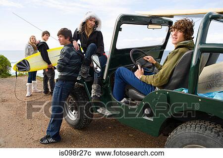 Stock Image - Teenagers with off road vehicle. Fotosearch