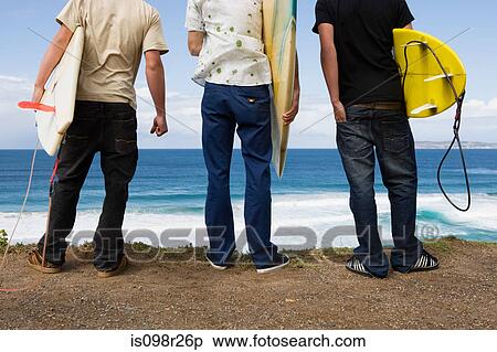 Stock Photography - Three surfers. Fotosearch