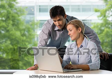 Colleagues with laptop View Large Photo Image Stock Image - Colleagues with laptop. Fotosearch