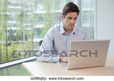 Man working on laptop View Large Photo Image Stock Image - Man working on laptop. Fotosearch