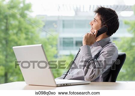 Picture - Office worker on telephone. Fotosearch