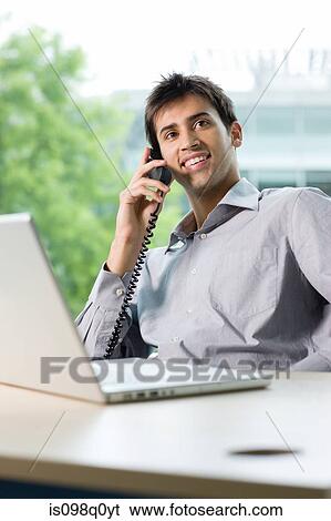 Stock Photograph - Office worker on telephone. Fotosearch