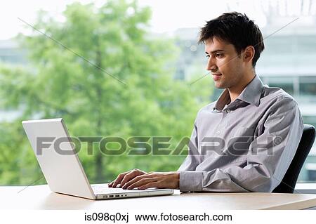 Office worker with laptop View Large Photo Image Stock Image - Office worker with laptop. Fotosearch