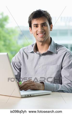 Office worker with laptop View Large Photo Image Stock Image - Office worker with laptop. Fotosearch