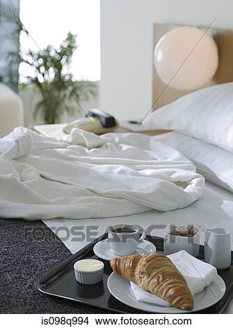 Bathrobe and breakfast on a hotel bed View Large Photo Image Picture - Bathrobe and breakfast on a hotel bed. Fotosearch