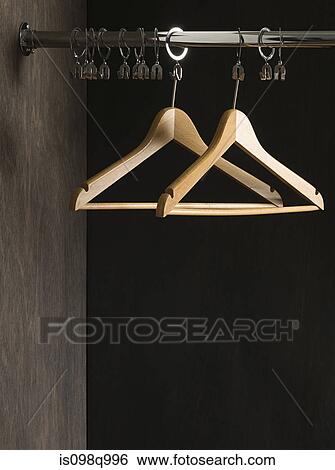 Clothes hangers in closet View Large Photo Image Stock Photograph - Clothes hangers in closet. Fotosearch