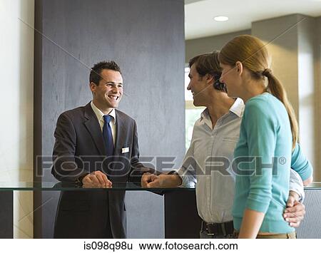 Couple at a hotel reception View Large Photo Image Stock Photograph - Couple at a hotel reception. Fotosearch