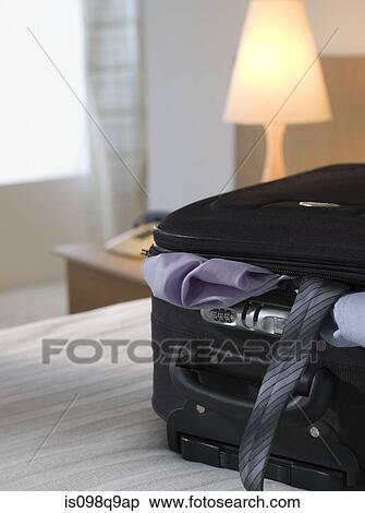 Full suitcase in a hotel room View Large Photo Image Stock Photography - Full suitcase in a hotel room. Fotosearch