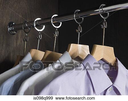 Shirts hanging in a closet View Large Photo Image Stock Photo - Shirts hanging in a closet. Fotosearch