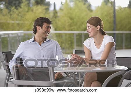Smiling couple at dining table View Large Photo Image Stock Photo - Smiling couple at dining table. Fotosearch