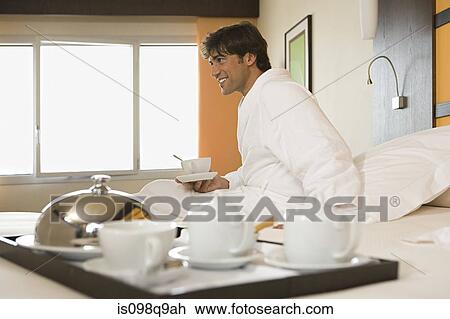 Smiling man in a hotel room View Large Photo Image Stock Image - Smiling man in a hotel room. Fotosearch