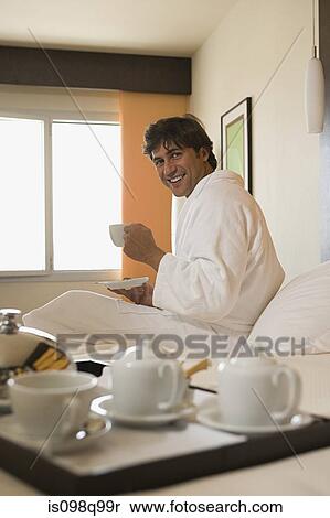Smiling man in a hotel room View Large Photo Image Stock Photography - Smiling man in a hotel room. Fotosearch