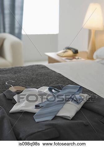 Stock Photograph - Suit and tie on a hotel bed. Fotosearch