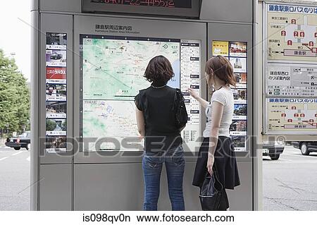 Friends looking at map View Large Photo Image Picture - Friends looking at map. Fotosearch