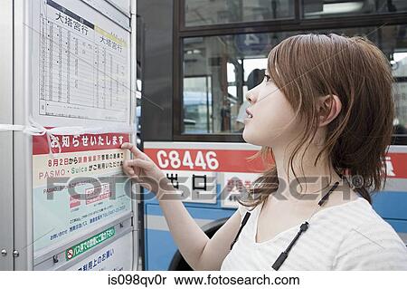 Young woman looking at bus timetable View Large Photo Image Stock Photography - Young woman looking at bus timetable. Fotosearch