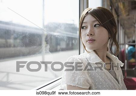 Young woman on train View Large Photo Image Stock Image - Young woman on train. Fotosearch