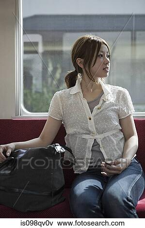Young woman on train View Large Photo Image Stock Photo - Young woman on train. Fotosearch