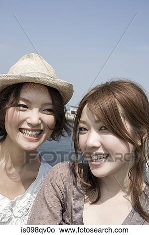 Young women at the coast View Large Photo Image Picture - Young women at the coast. Fotosearch