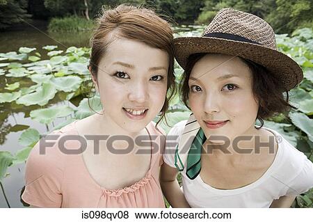 Young women in garden View Large Photo Image Stock Photo - Young women in garden. Fotosearch
