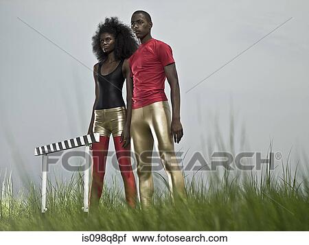 Stock Image - Athletes by hurdle. Fotosearch