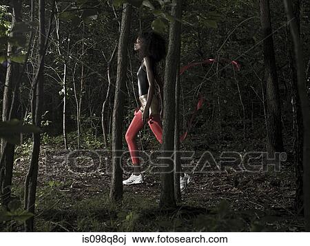 Female athlete in forest View Large Photo Image Stock Image - Female athlete in forest. Fotosearch