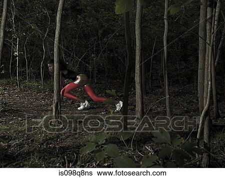 Stock Photograph - Female athlete in forest. Fotosearch