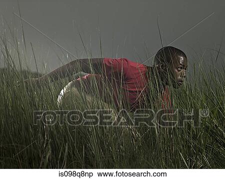 Male athlete in grass View Large Photo Image Stock Photography - Male athlete in grass. Fotosearch