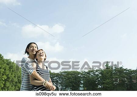 Young couple outdoors View Large Photo Image Stock Photograph - Young couple outdoors. Fotosearch